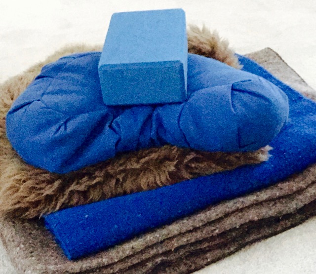 yoga props: block, shearling pad, blankets